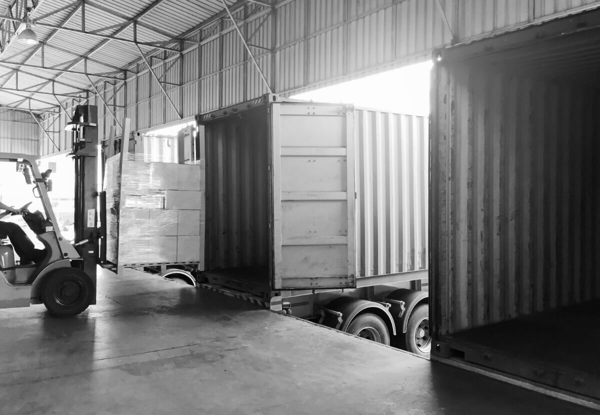 forklift loading a pallet onto a container